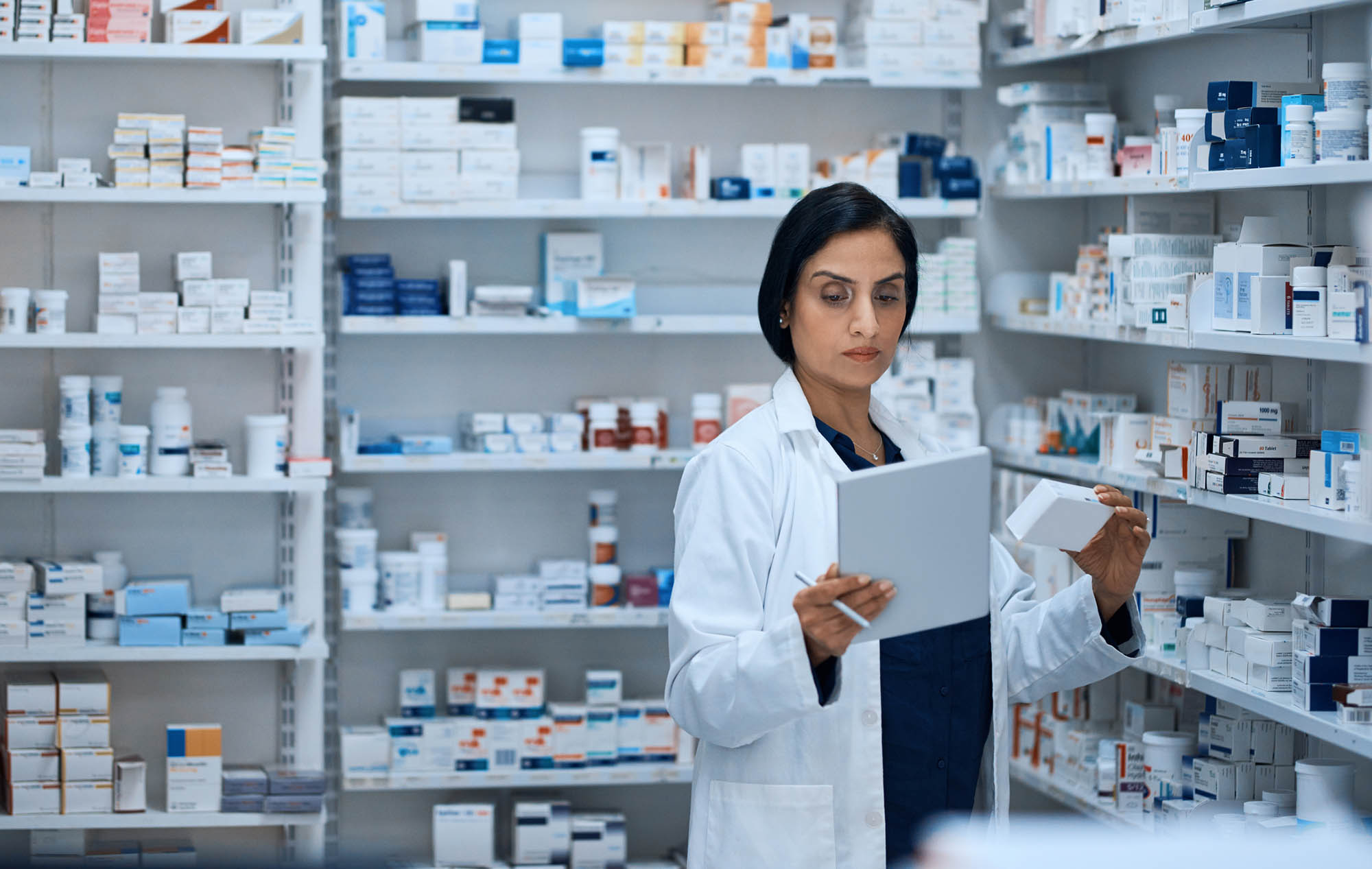 female pharmacist checking medicine